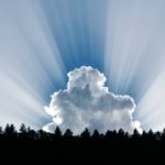 Cloud illuminated by rays of light over the earth, reflecting on the Lord of All the Earth who reigns with majesty and power.