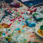 Messy art supplies and paint splatters, contrasting with the truth that God is perfect in His character, works, and ways.