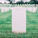 Image of a tombstone in a graveyard, symbolizing the victory of Jesus over death and the promise of eternal life.