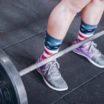 Person preparing to lift a heavy barbell illustrating how God Who Equips gives strength to do what seems impossible.