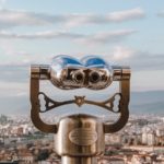 Viewing telescope overlooking a city, representing a clearer perspective of our Forbearing God who shows patience, kindness, and mercy.