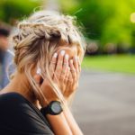 Woman with her face in her hands, struggling to trust that God’s understanding is inscrutable when prayers feel unanswered.