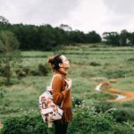 Woman standing on a hillside path, reflecting on how God Is My Leader and guides her in the way she should go.