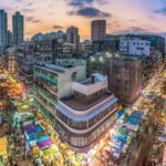 Busy city streets at sunset, reflecting on Jesus as the Lord of the Harvest who sends workers to share the good news.