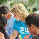 Woman serving children outdoors, reflecting on how our lives can become an offering to God as we walk in love.