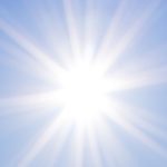 Radiant beams of light shining across a blue sky, reflecting the radiant glory of Christ.