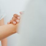 Two people clasping hands, representing reconciliation through Jesus our reconciler, who brings us into a right relationship with God.