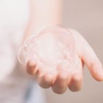 Hand holding soap suds, representing the cleansing offered by Jesus, our pure Savior.