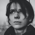 Woman looking upward thoughtfully, reflecting on how God is rich in mercy and has given believers eternal hope in Christ.
