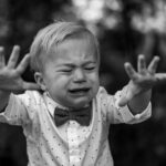 Crying child reaching out, illustrating how we cry out in need and are heard by the God Who Hears.