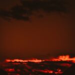 A blazing fire under a dark sky, symbolizing that God Is A Consuming Fire and His holy judgment against sin.