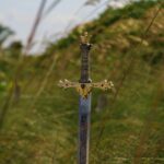 Sword planted in the ground symbolizing battle and victory through God Of The Armies of Israel, who gives strength to overcome every giant