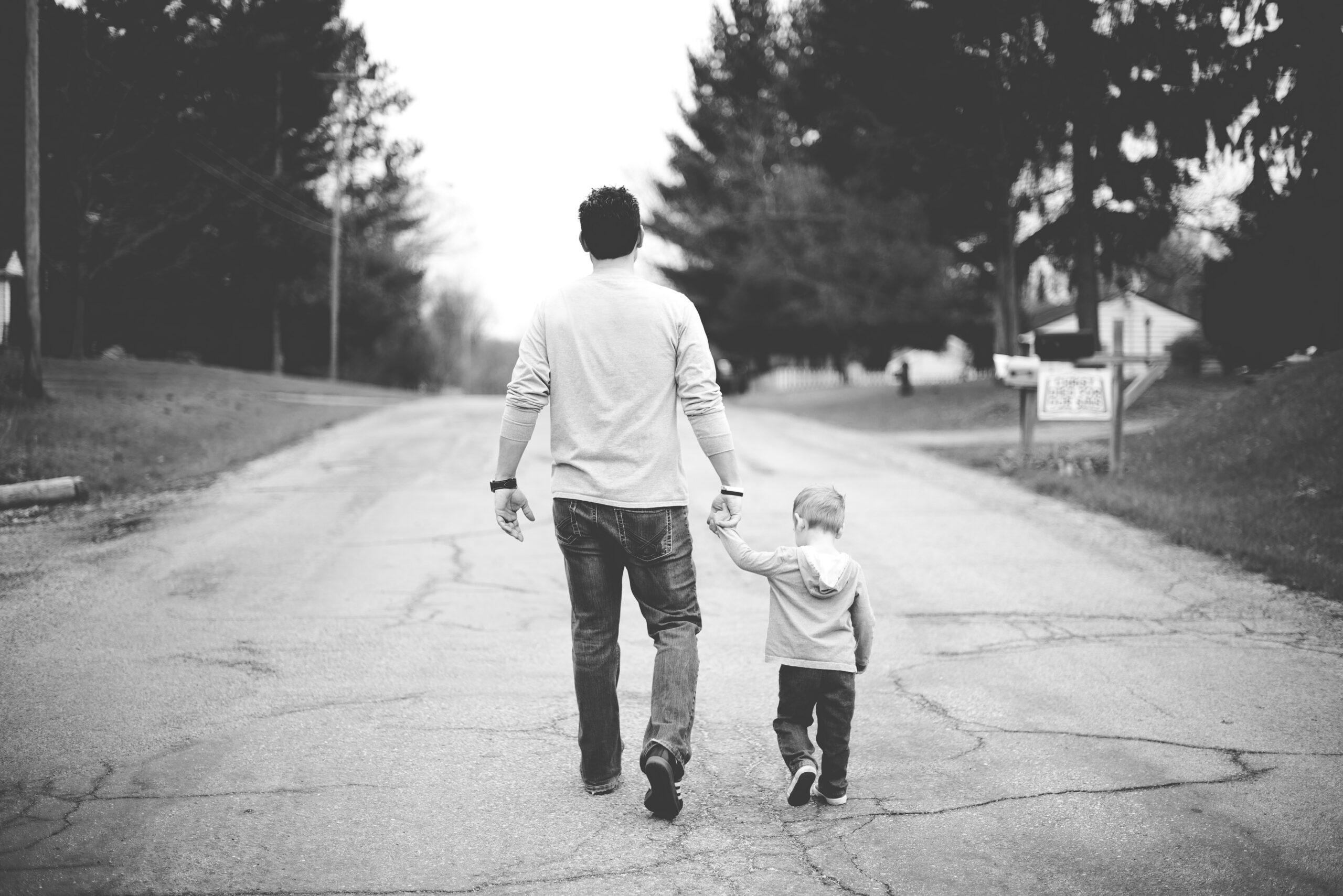 A loving father holding the hand of his child, symbolizing God's care for His children.