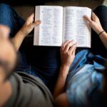 Two people reading the Bible together, seeking strength in Jehovah-Nissi, the Lord our banner in spiritual battle.