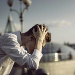 Person in distress with head in hands, seeking guidance and hope in Jesus My Instructor.