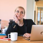 Woman looking unmotivated at her desk, reflecting the need for Jesus, the quickening Spirit, to arouse and invigorate us.