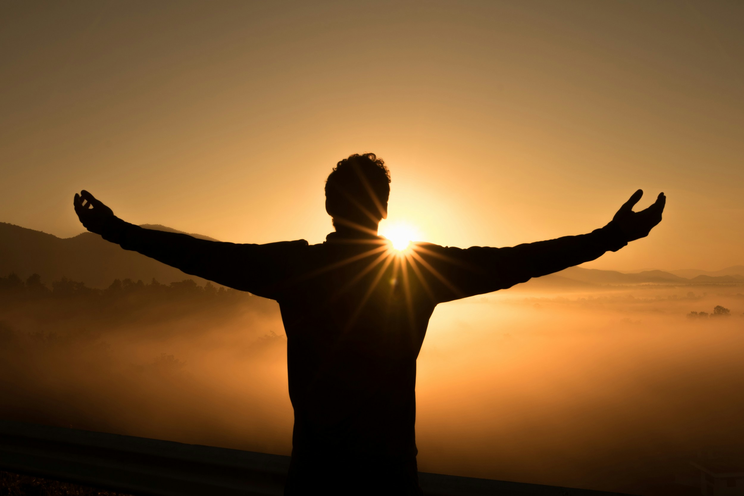 A man holding up his arms, praising God