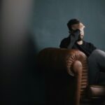 Man sitting alone with his hand on his head, reflecting on the truth that nothing is too difficult for God.