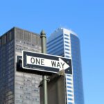 One way sign pointing forward, reflecting on Jesus as the one God and mediator who brings us to the Father.