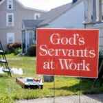 Sign reading “God’s Servants at Work,” illustrating serving under Jesus as the Head of the Church and following His direction in ministry.