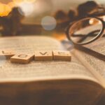 Open Bible with the word love spelled out, reflecting how God is Great in Lovingkindness and pours out His love on us