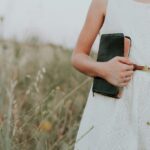 Person holding a Bible close, symbolizing dependence on the Holy Spirit who teaches, guides, and reminds believers of God’s truth.