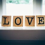 Wooden blocks spelling love, reflecting on how God Is Love and calls believers to extend sacrificial love to others.