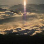 Sunbeam shining above the clouds, reflecting God as the Majesty on High and His supreme glory and authority.