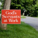 Sign reading God’s Servants at Work, reflecting on Jesus, God’s Servant, who bore our sins and calls us to serve others.